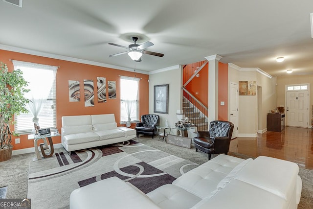 living room with carpet flooring, ceiling fan, plenty of natural light, and crown molding