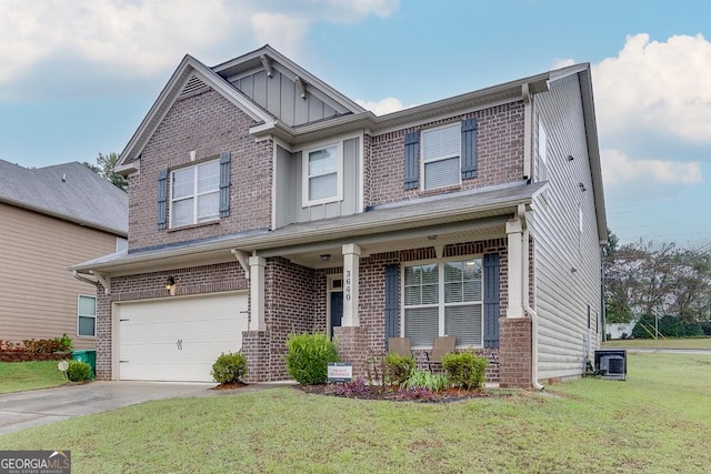 craftsman-style house featuring a front yard, a porch, a garage, and central AC unit