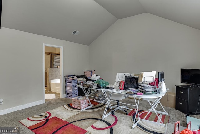 home office featuring carpet flooring and vaulted ceiling