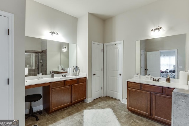 bathroom with a shower with door and vanity