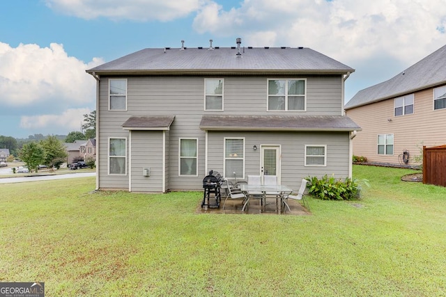 back of house with a patio area and a lawn