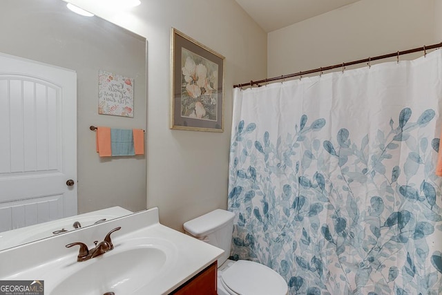 bathroom featuring vanity and toilet