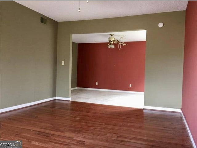 empty room featuring hardwood / wood-style floors and a notable chandelier