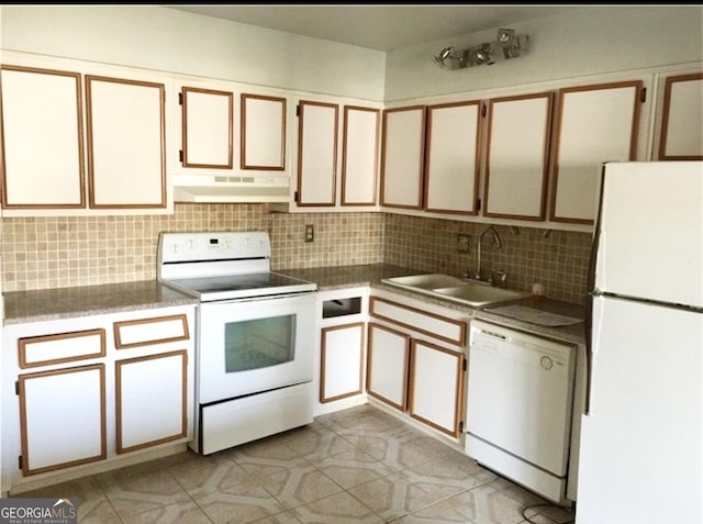 kitchen with tasteful backsplash, sink, white cabinets, and white appliances