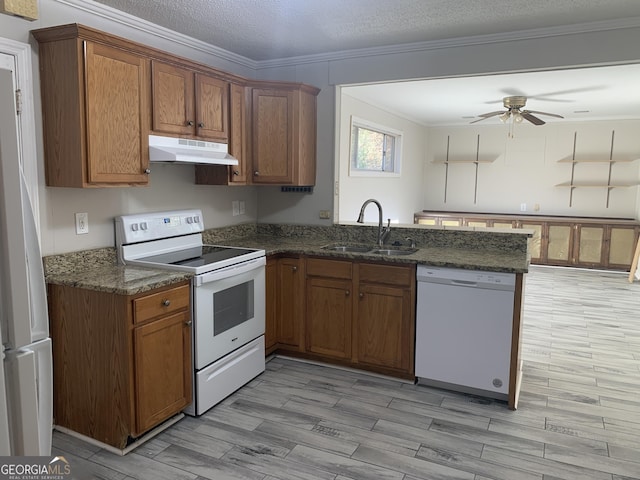 kitchen with sink, white appliances, kitchen peninsula, crown molding, and a textured ceiling