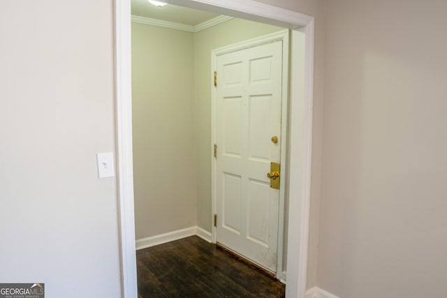 entryway with crown molding and dark wood-type flooring