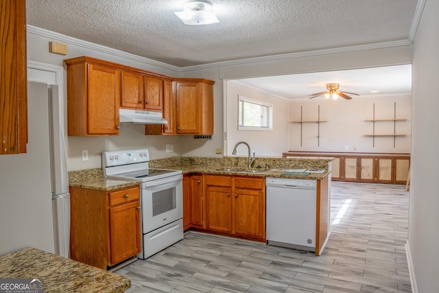 kitchen with white appliances, ornamental molding, sink, and a textured ceiling