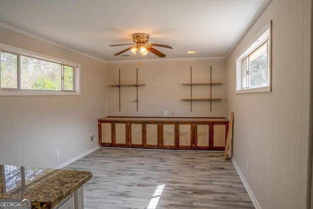 interior space featuring crown molding, light hardwood / wood-style flooring, and ceiling fan