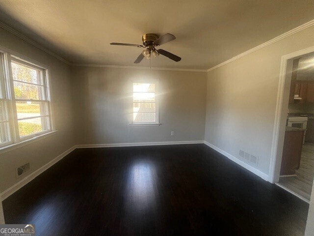 unfurnished room featuring ornamental molding, ceiling fan, and dark hardwood / wood-style floors