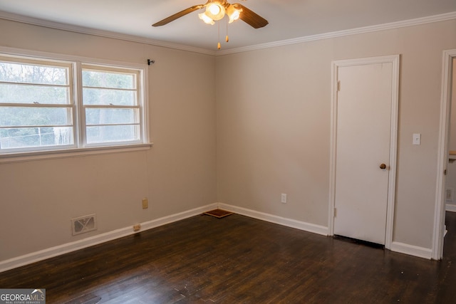 spare room featuring dark wood-type flooring, ceiling fan, and ornamental molding