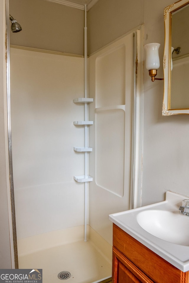 bathroom with vanity and a shower