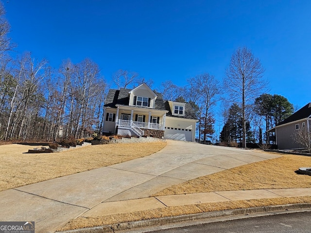 view of front of home featuring a porch and a garage