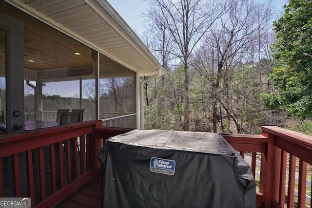 wooden deck with a sunroom