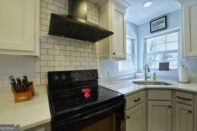 kitchen with backsplash, sink, wall chimney range hood, electric range, and white cabinetry