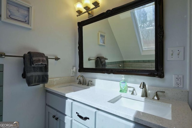 bathroom with a skylight and vanity