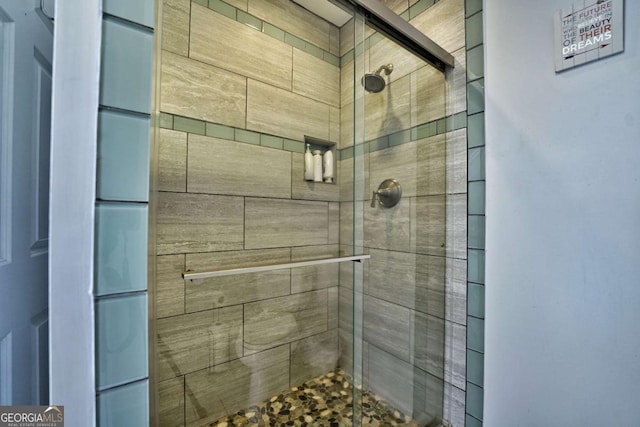 bathroom with a shower with shower door