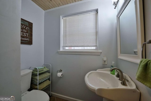 bathroom with tile patterned floors, ornamental molding, sink, wooden ceiling, and toilet