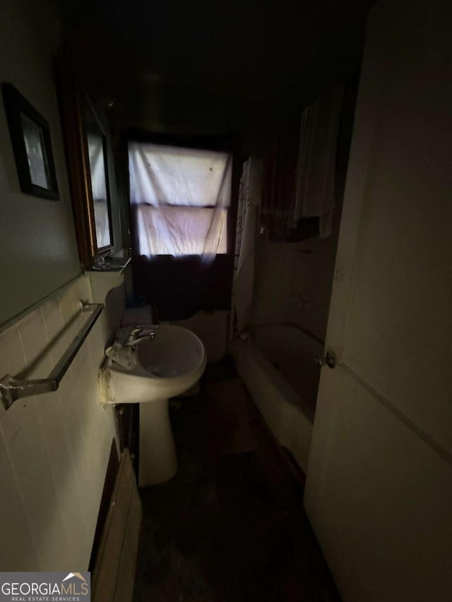 bathroom featuring shower / tub combination and sink