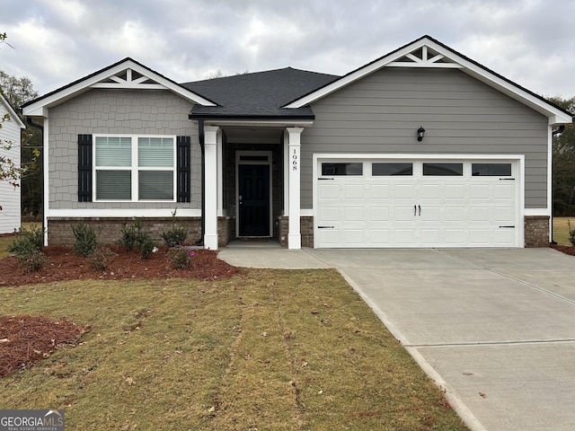 craftsman-style house featuring a garage and a front yard