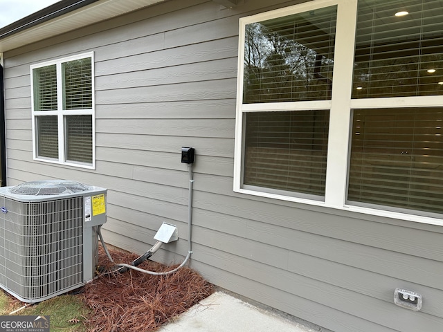 view of side of home featuring cooling unit