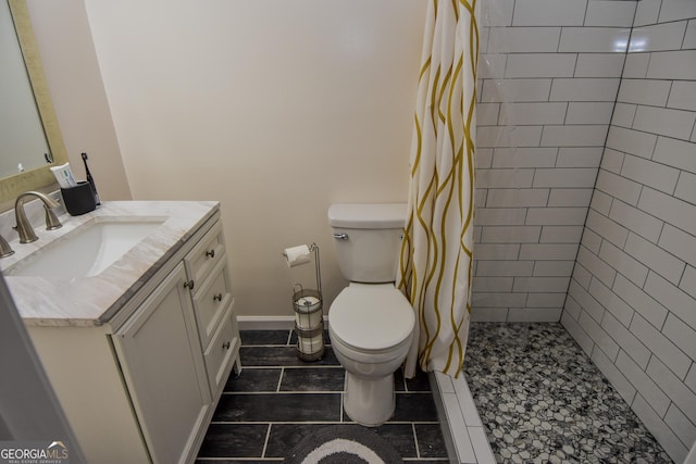 bathroom featuring vanity, toilet, and walk in shower