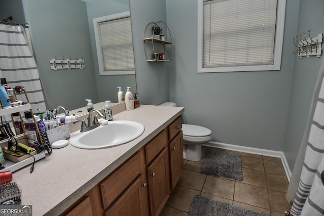 bathroom with tile patterned floors, vanity, and toilet