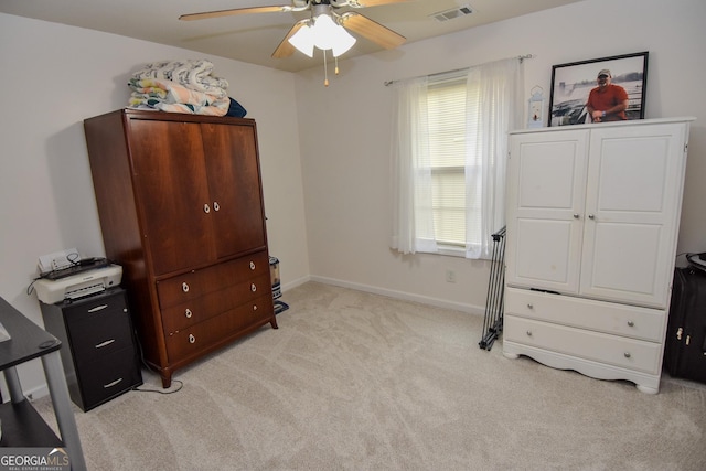 interior space with ceiling fan and light colored carpet