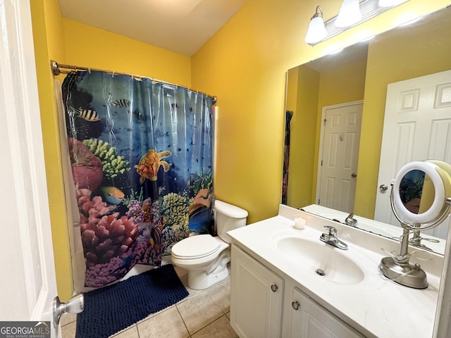 bathroom featuring toilet, tile patterned flooring, and vanity