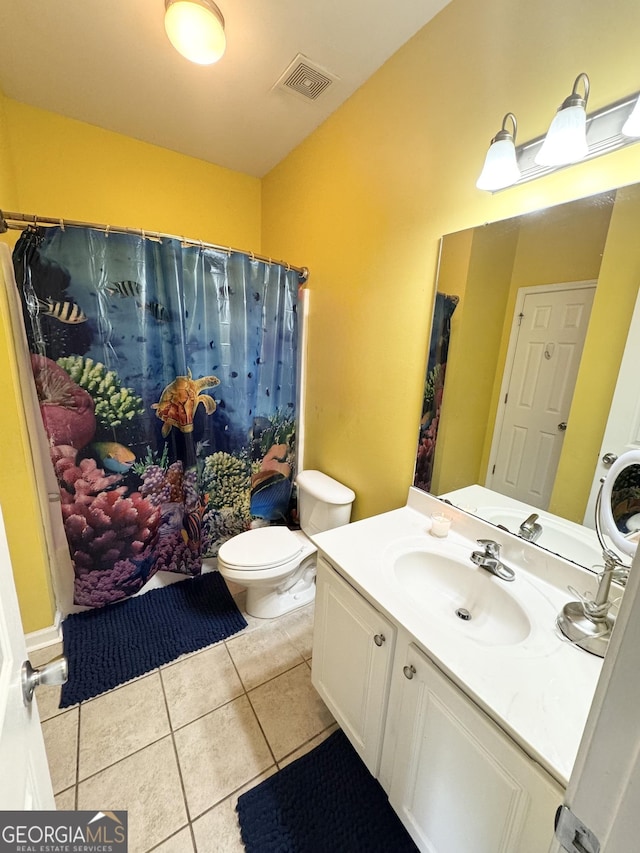 bathroom featuring tile patterned floors, toilet, and vanity