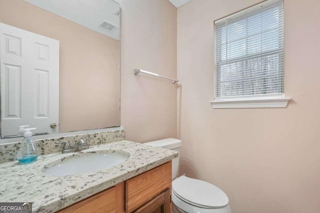 bathroom with vanity and toilet