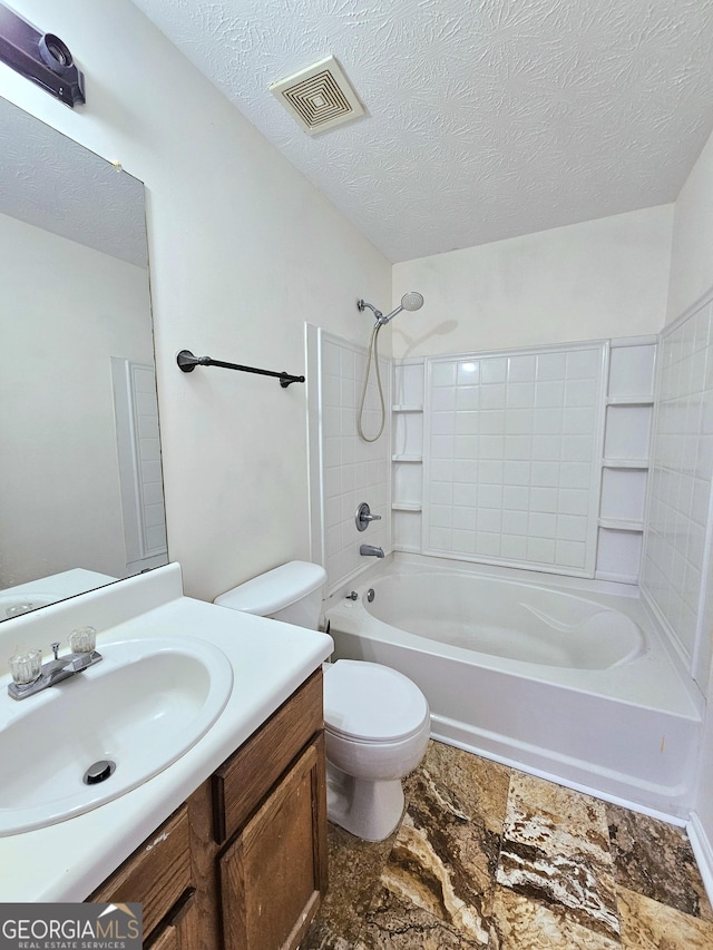 full bathroom featuring vanity, shower / bathing tub combination, a textured ceiling, and toilet