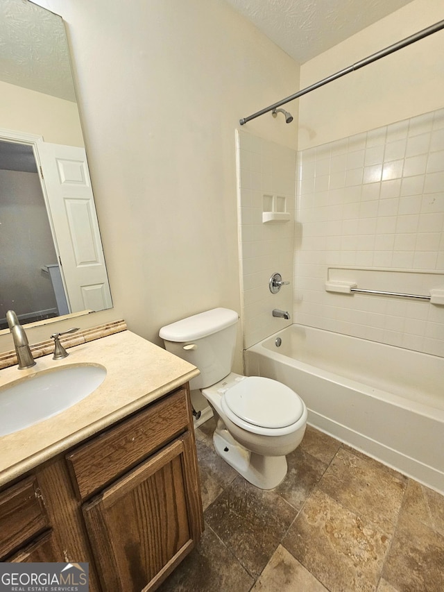 full bathroom featuring vanity, toilet, washtub / shower combination, and a textured ceiling