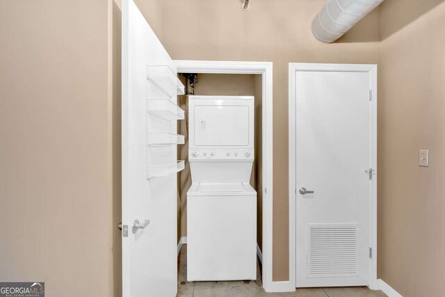 kitchen with stainless steel appliances, light brown cabinets, light tile patterned flooring, and sink