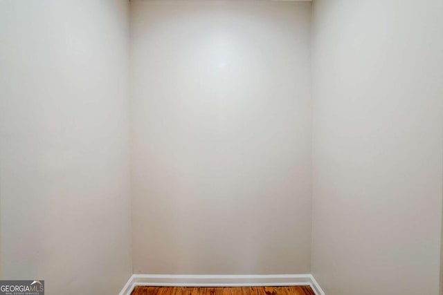 unfurnished room with wood-type flooring