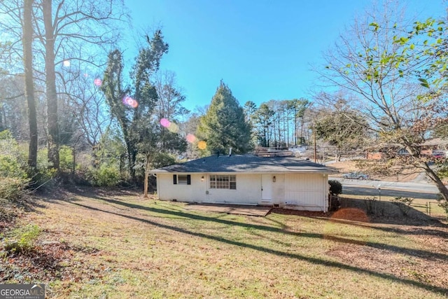 back of house with a lawn