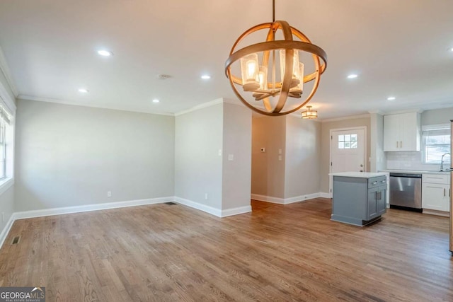 kitchen featuring gray cabinetry, backsplash, an inviting chandelier, white cabinets, and stainless steel dishwasher