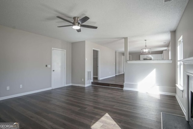 unfurnished living room featuring a textured ceiling, a premium fireplace, ceiling fan, and dark hardwood / wood-style floors