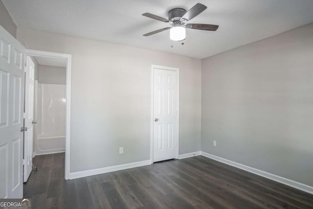 unfurnished bedroom featuring a textured ceiling, ceiling fan, and dark hardwood / wood-style floors