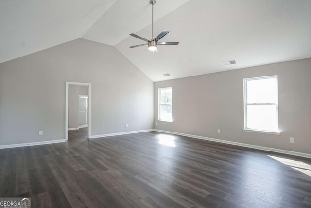 empty room featuring dark hardwood / wood-style floors, ceiling fan, and vaulted ceiling