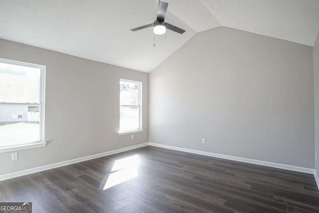 empty room featuring dark wood-type flooring, ceiling fan, and lofted ceiling