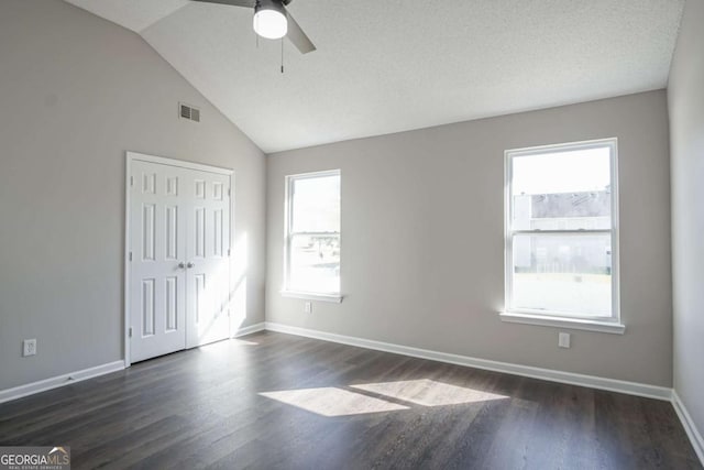 unfurnished room with dark hardwood / wood-style floors, ceiling fan, a healthy amount of sunlight, and lofted ceiling