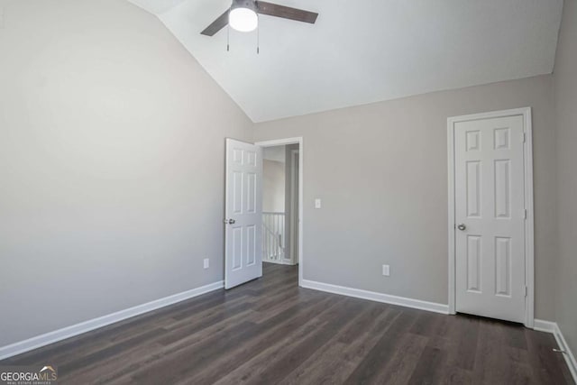 unfurnished bedroom featuring dark wood-type flooring, ceiling fan, and lofted ceiling