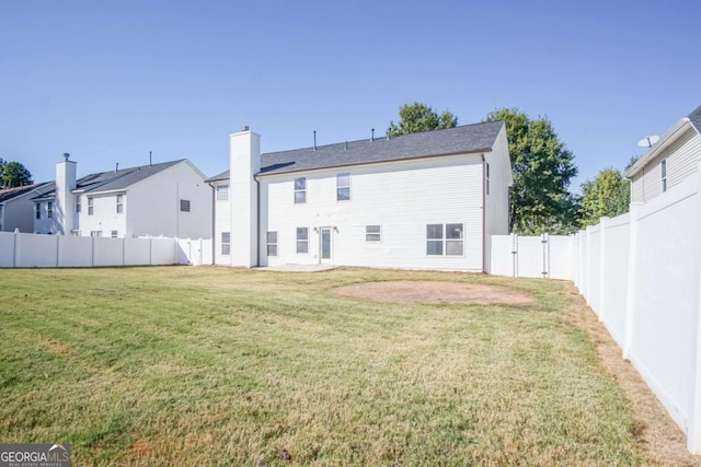 rear view of property with a lawn