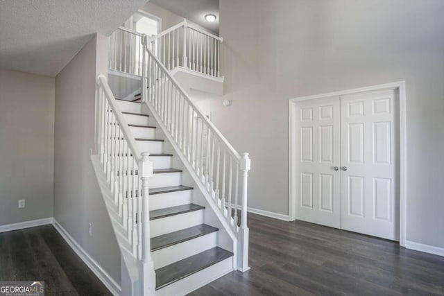 stairs with hardwood / wood-style floors and a textured ceiling