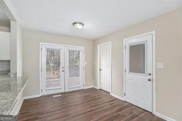 interior space with french doors and dark wood-type flooring