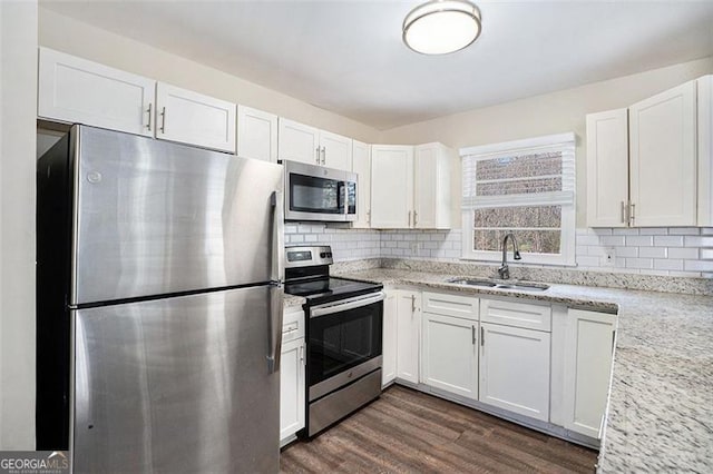 kitchen with stainless steel appliances, white cabinetry, and sink