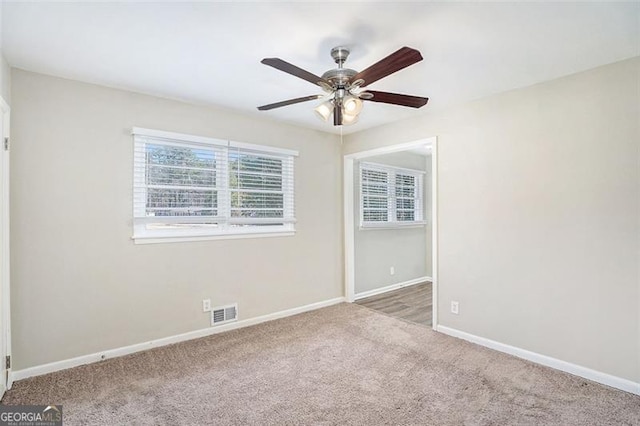 carpeted empty room with ceiling fan