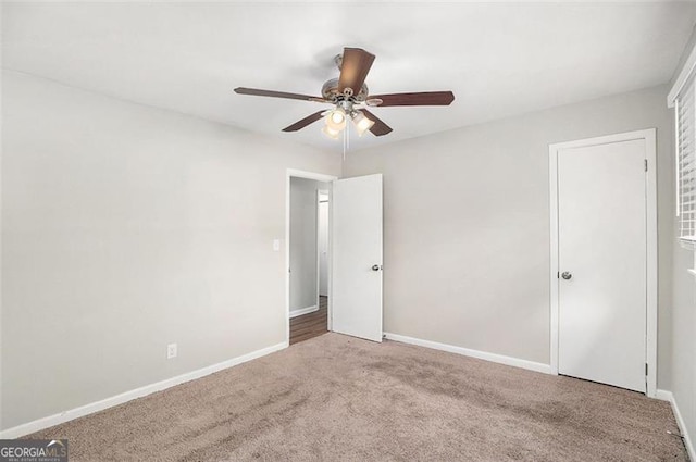 empty room featuring ceiling fan and carpet floors