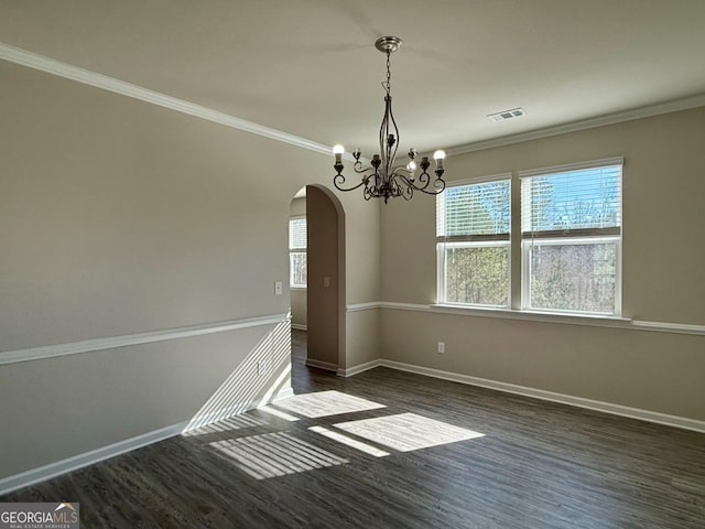 unfurnished dining area with dark wood-type flooring, crown molding, and a notable chandelier