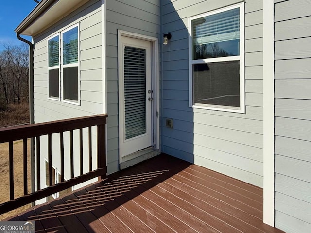 view of exterior entry featuring a wooden deck